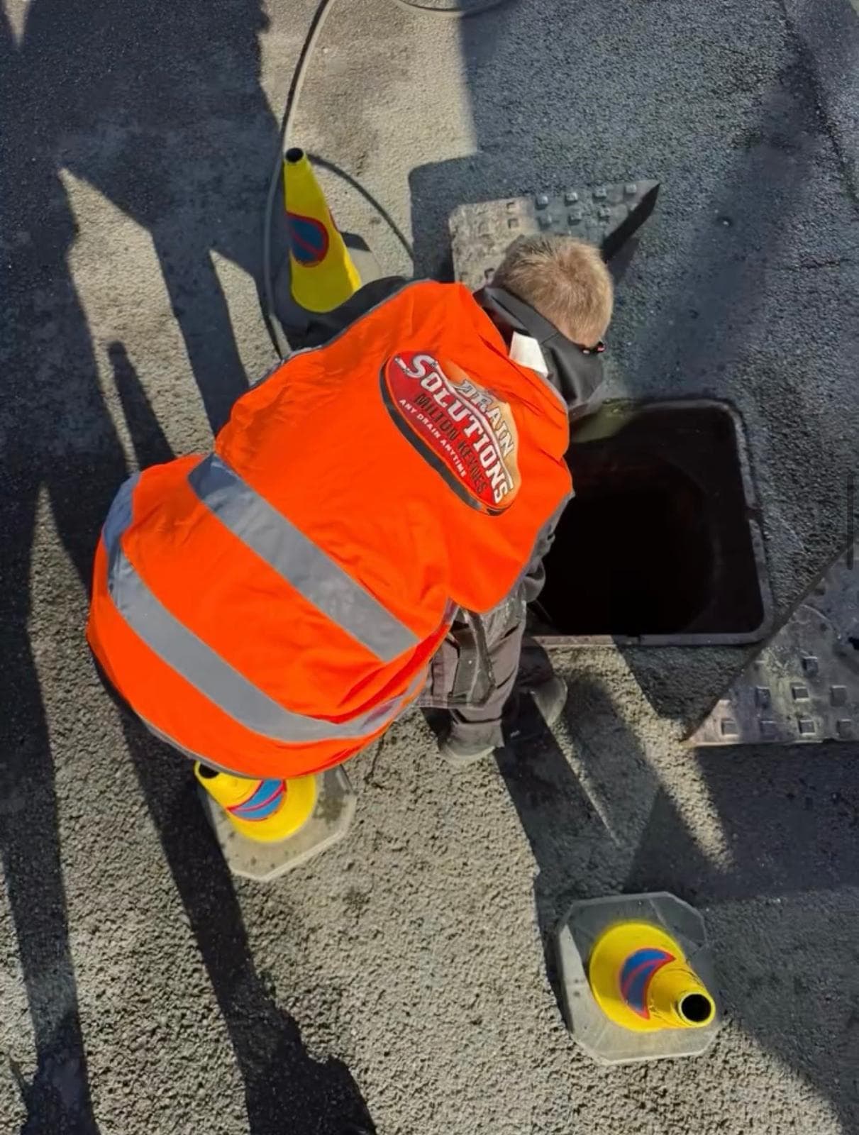 Drain Solutions MK engineer clearing a blocked manhole